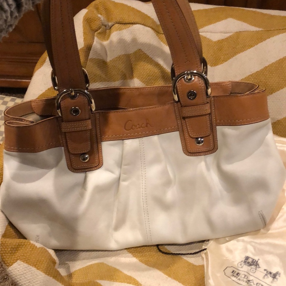 white and tan coach bag.